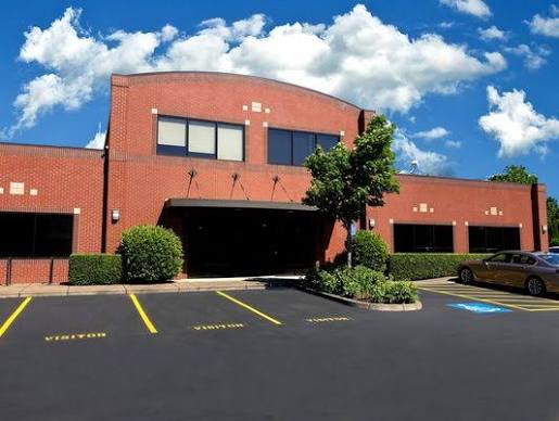 Red brick office building with a covered entrance at 2896 Crescent Ave in Eugene, Movement Improvement's new location